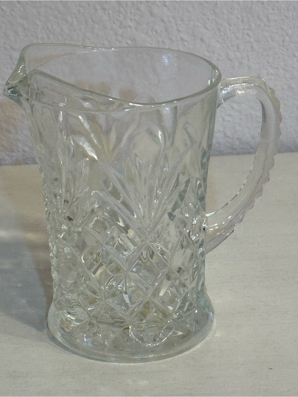 Clear Pressed Glass Creamer with a quilted diamond and fan pattern.
